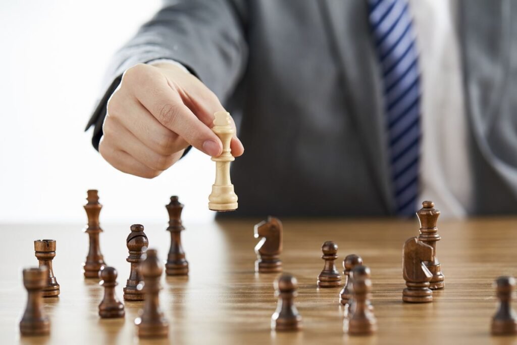 challenges faced by a businessman while playing a chess in black suit