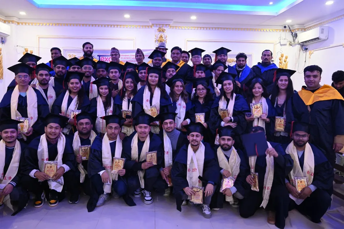 Graduating students in academic gowns holding certificates at a Texas International College convocation ceremony