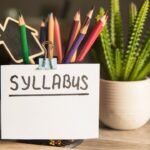 pencil cup holding color pencils and syllabus written card